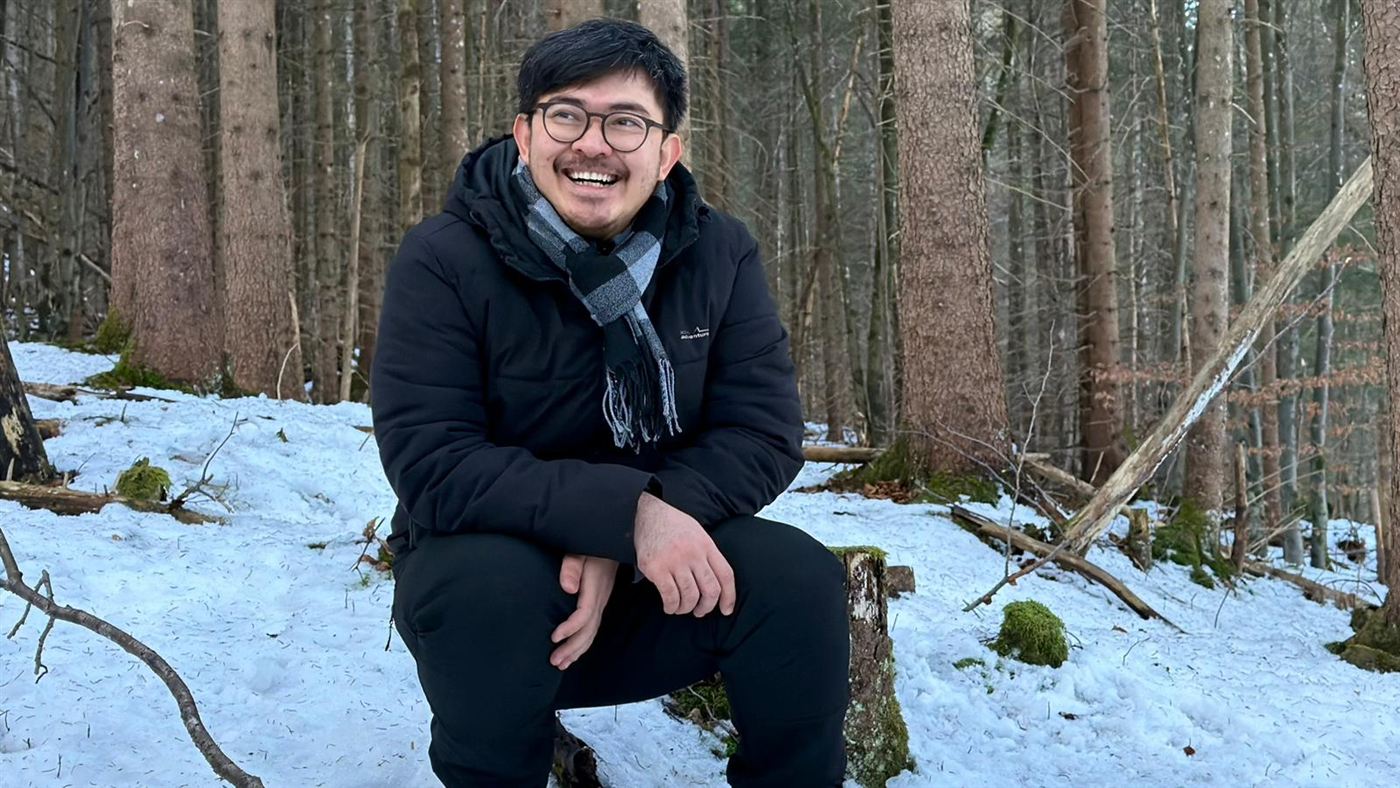 Kaung Sint Tha laughing in a snowy forest